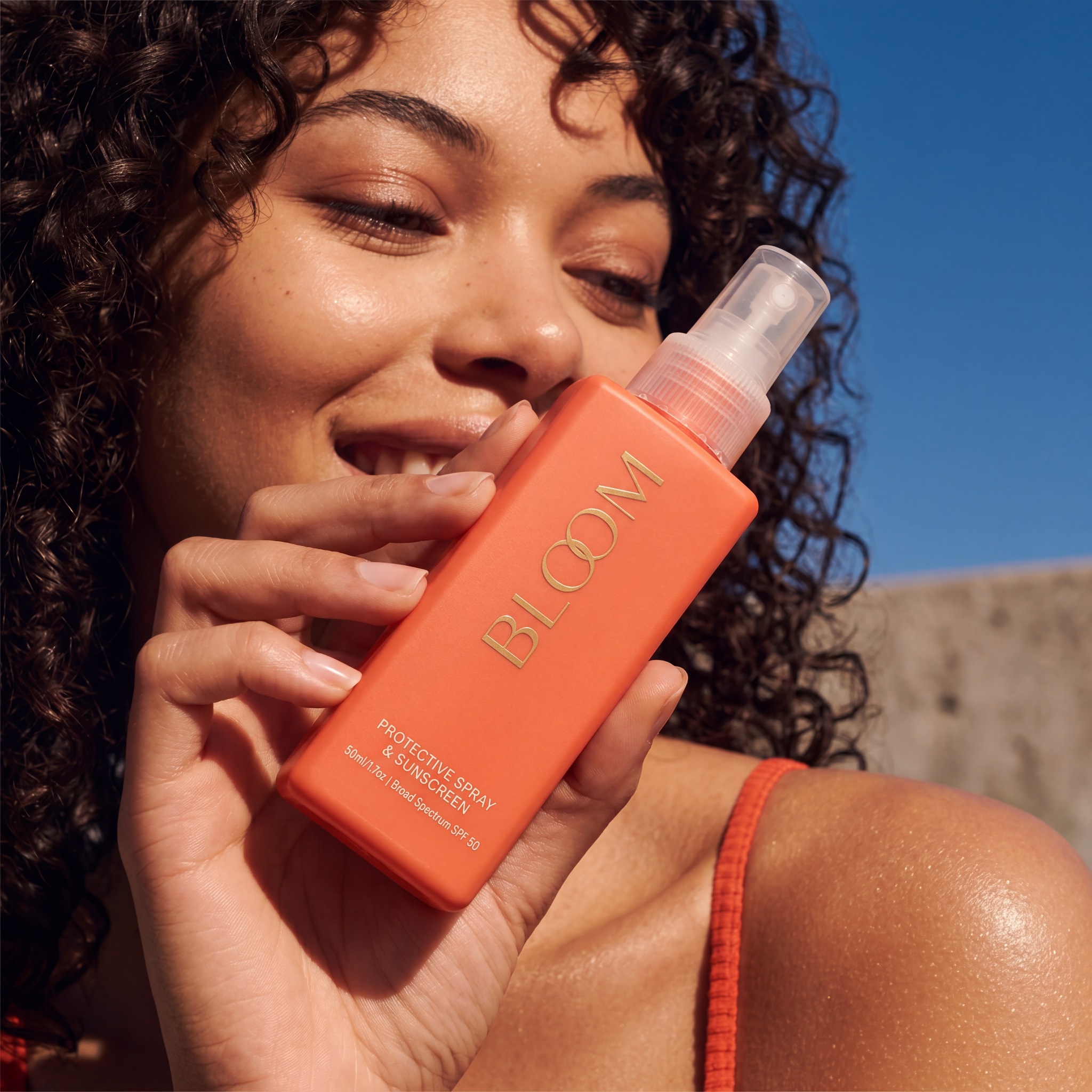 Orange sunscreen product campaign visual for skincare brand